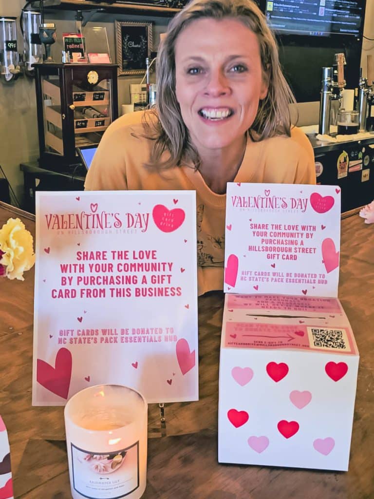woman standing behind gift card box for valentines day