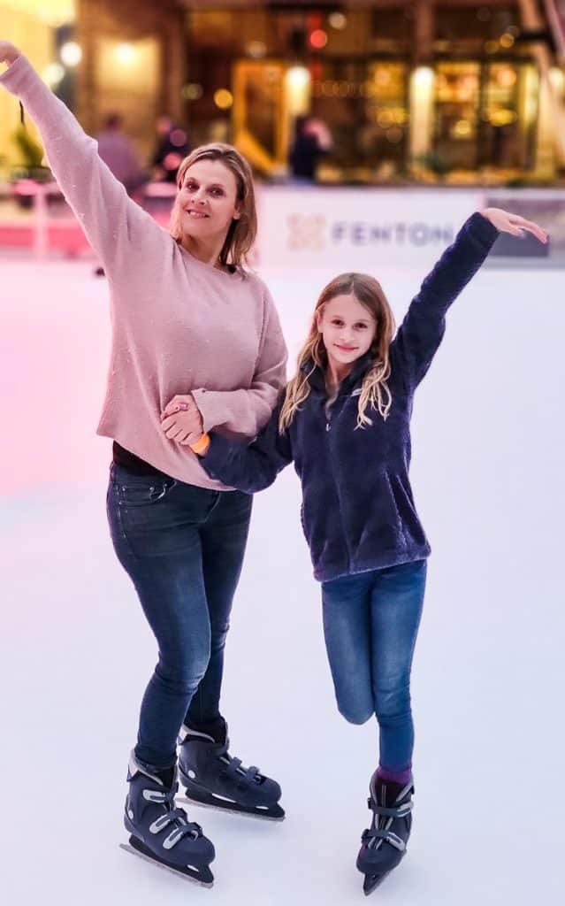 Mom and daughter ice skating.
