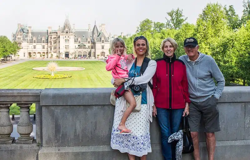 family posing in front of biltmore hourse