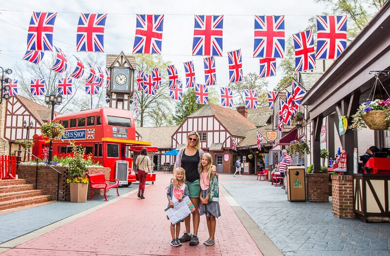mother and daughters standing under british flags in busch gardens