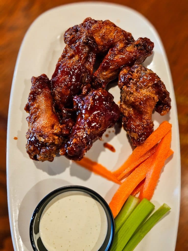 Plate of chicken wings and carrots and celery.