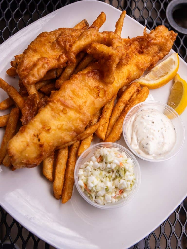 Plate of fish and chips with coleslaw.