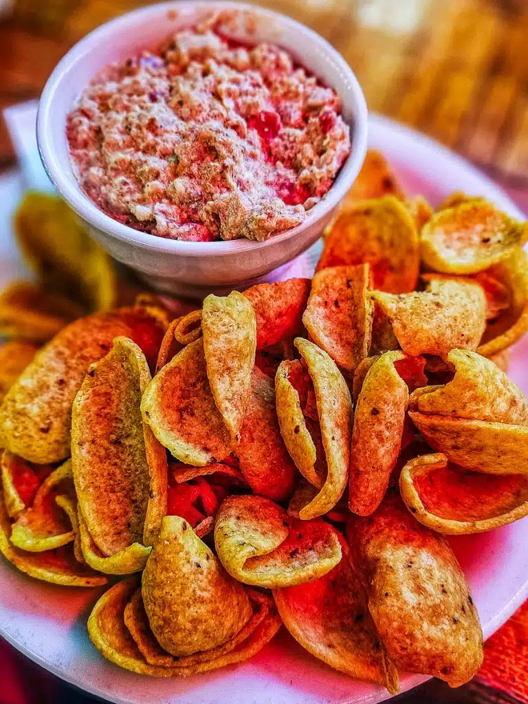 Plate of chips and sausage dip.