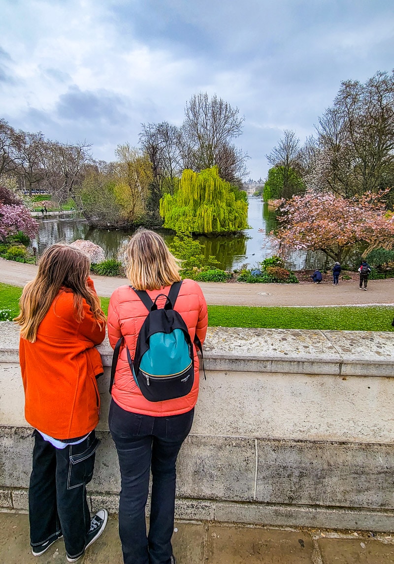 Mother and daughter standing in a park looking at gardens.
