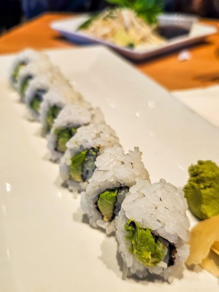 Plate of sushi with avocado.