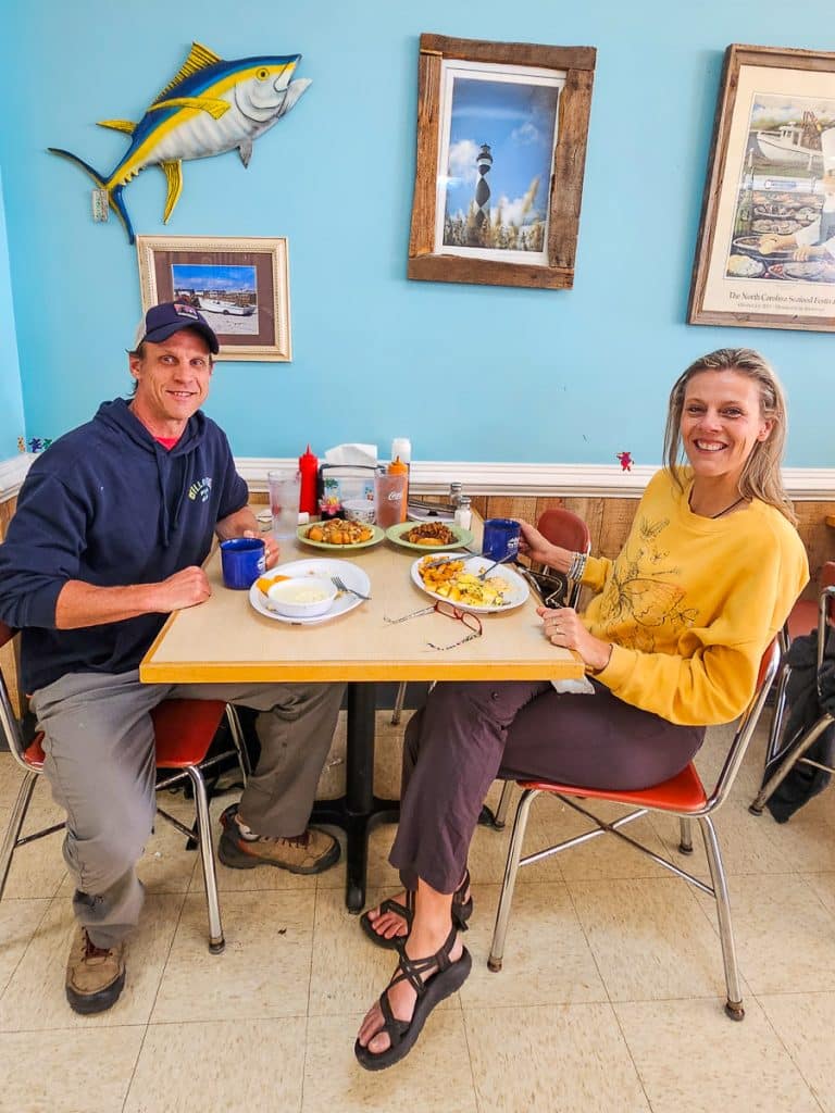 Man and woman sitting in restaurant having breakfast.