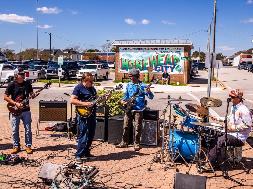 Blues band playing on a sidewalk.
