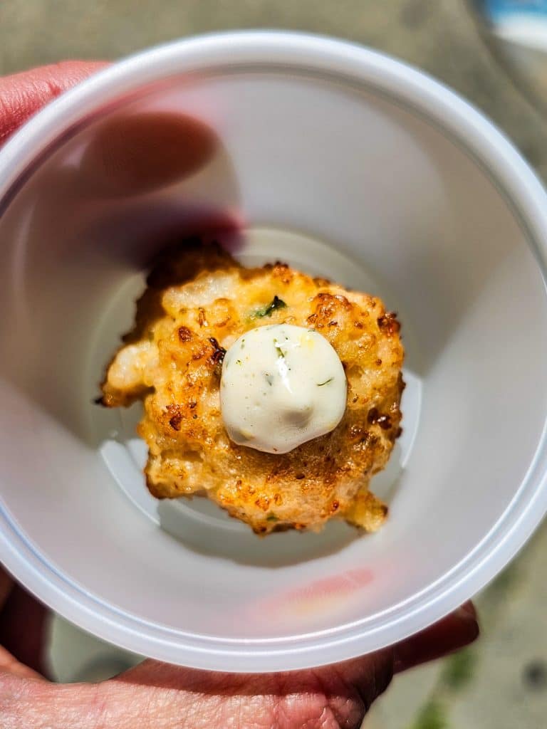 Small fried cheese ball in a cup.
