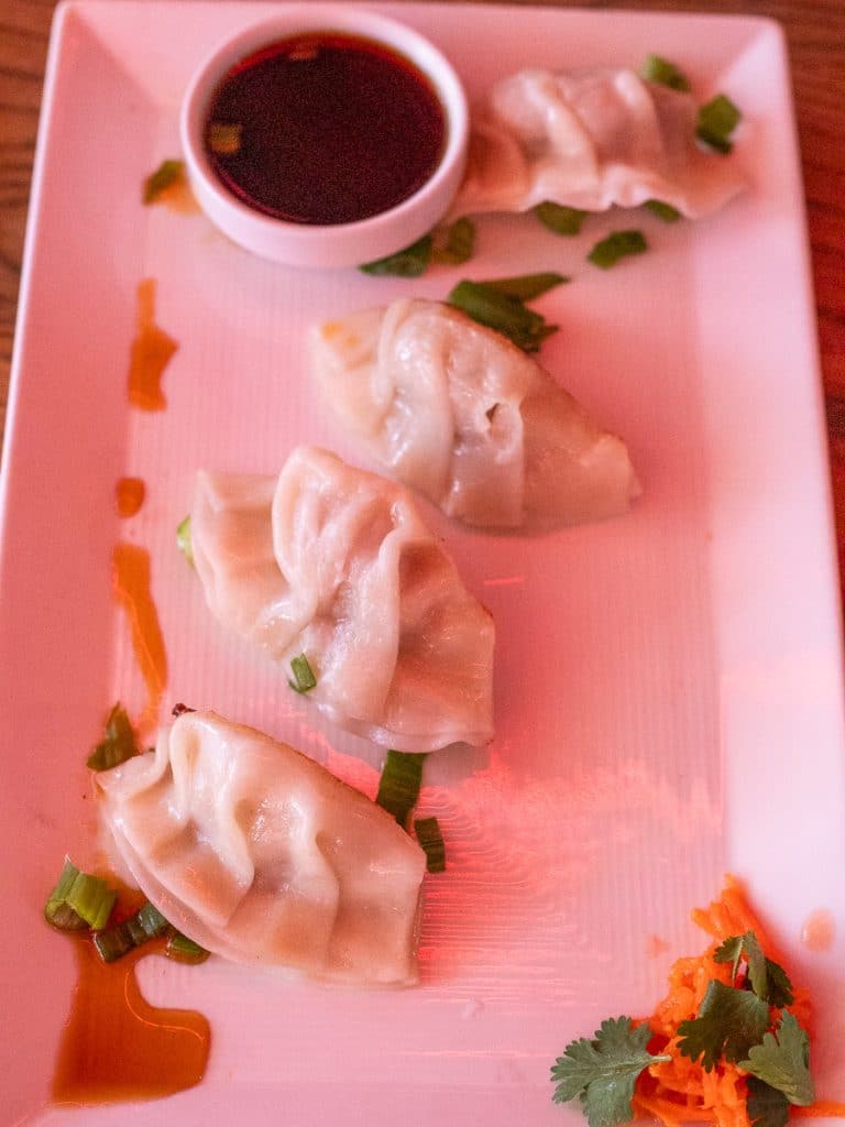 Three dumplings on a plate.