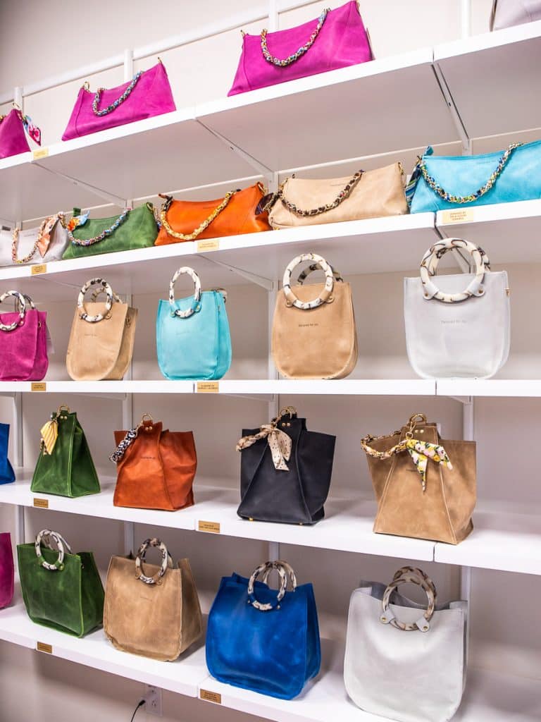 Handbags for sale in a store.