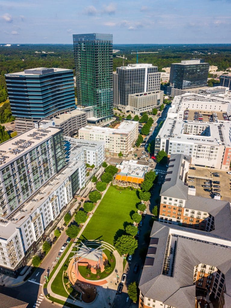 Aerial view of a shopping district called North Hills with a green park in the middle.