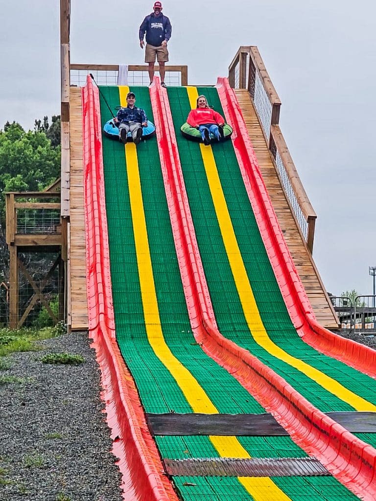 Two people going down a giant slide.