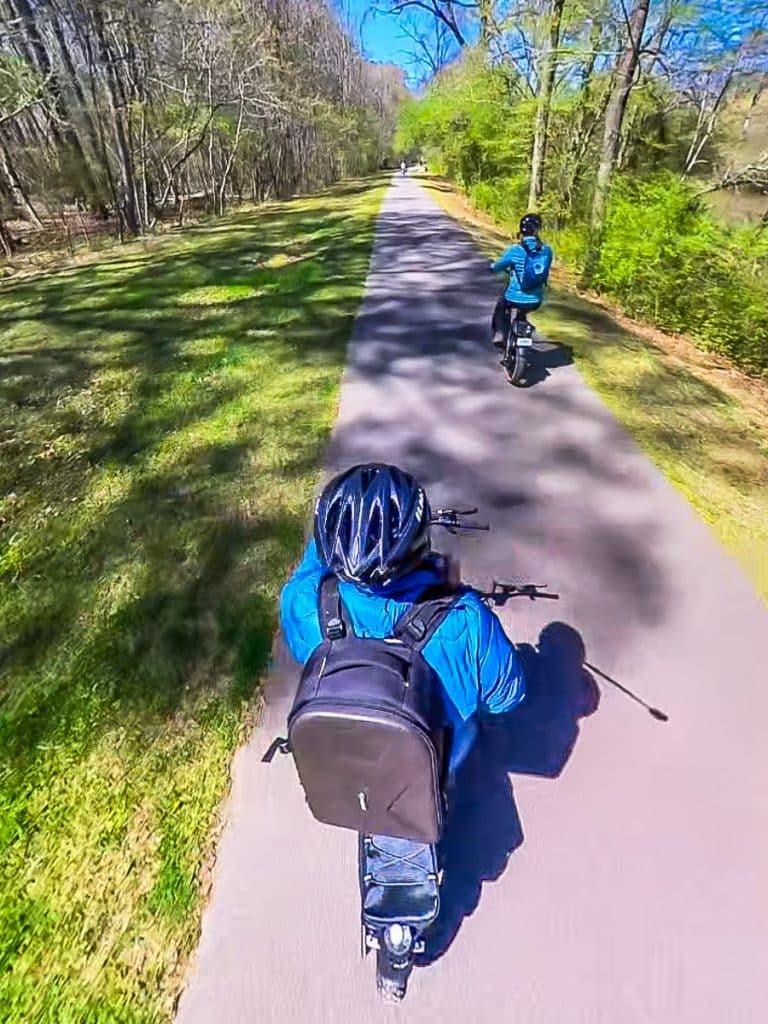 two people riding bikes on Neuse river greenway
