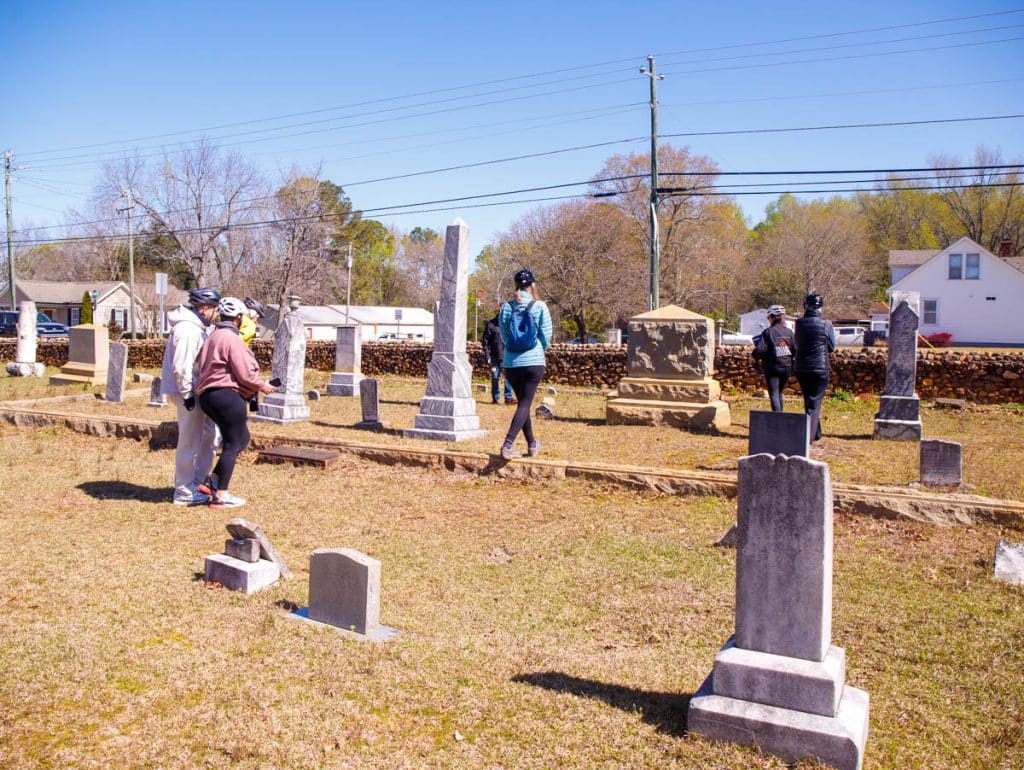 people walking around cemetery in clayton