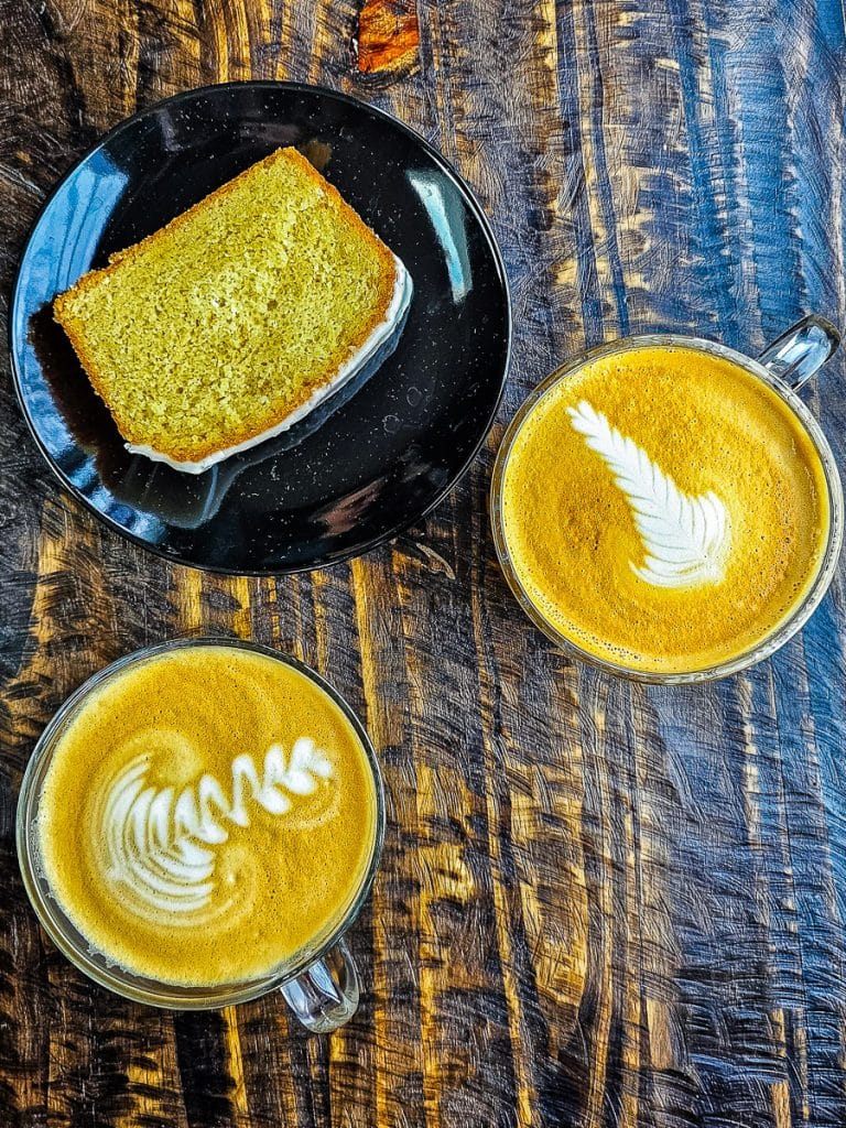 Two mugs of coffee and lemon cake.