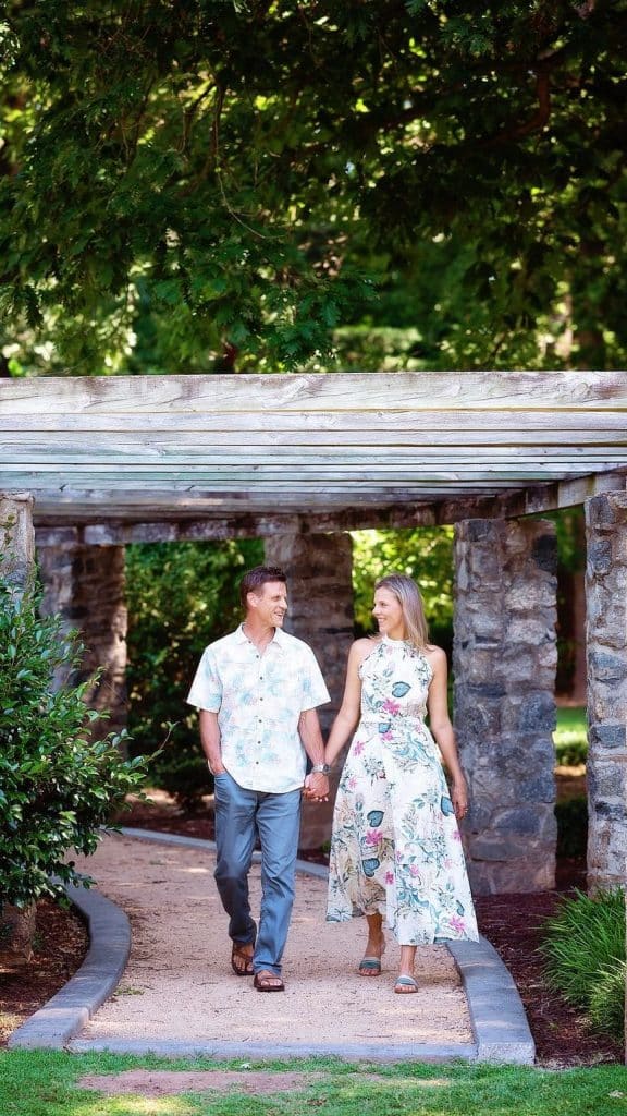 couple walking under pagoda in raleigh rose garden