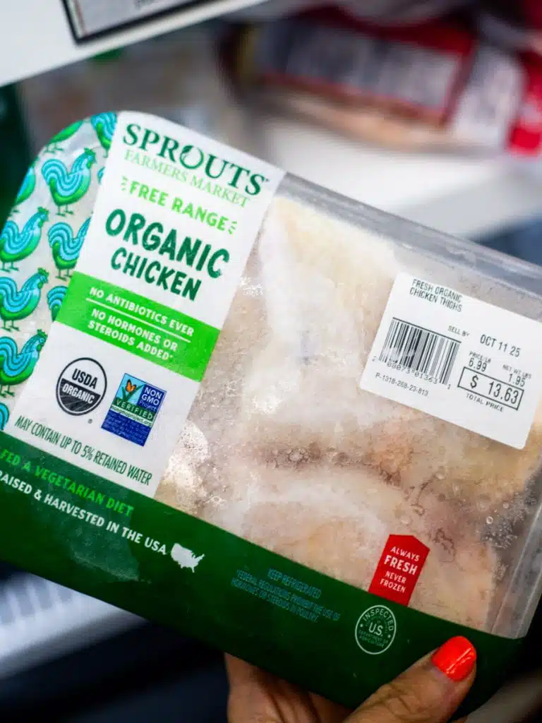 woman holding organic chicken 