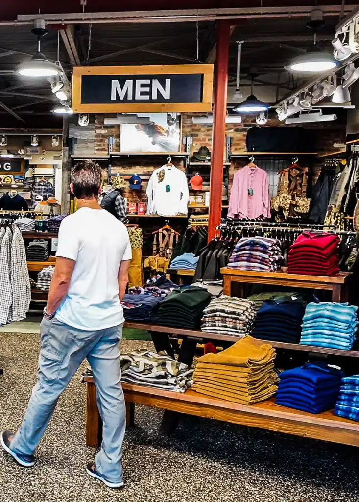 Man looking at clothes in a store.