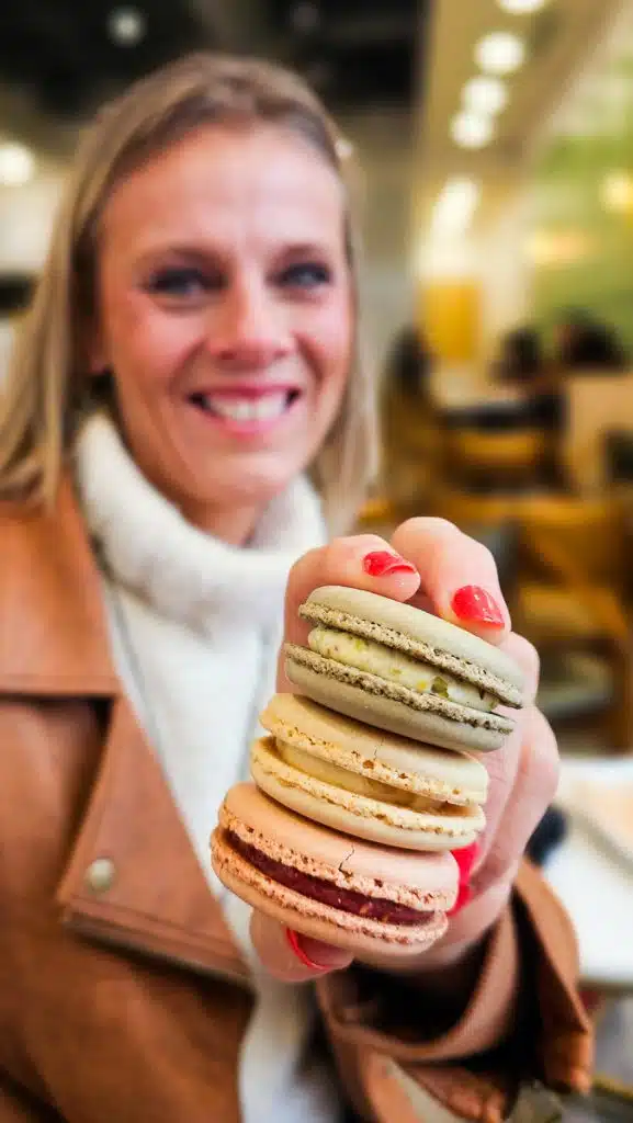 woman holding macarons from tous les jour bakery