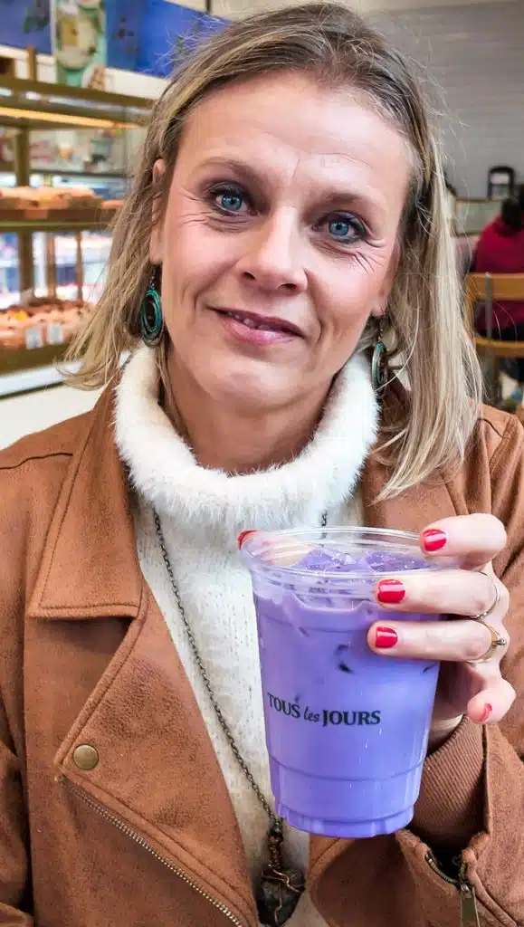 woman holding purple ube latte