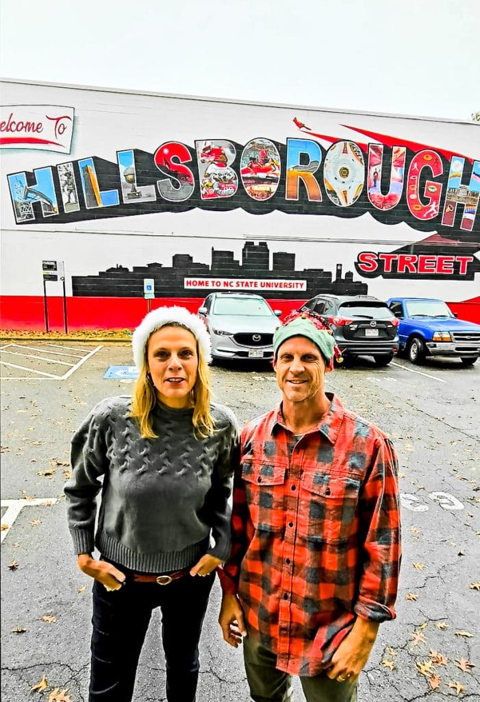 couple in front of hillsborough st mural with santa hats on