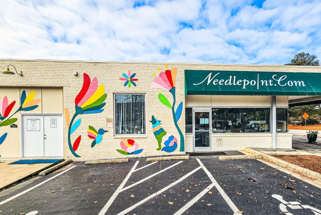 exterior of needlepoint with mural on side wall