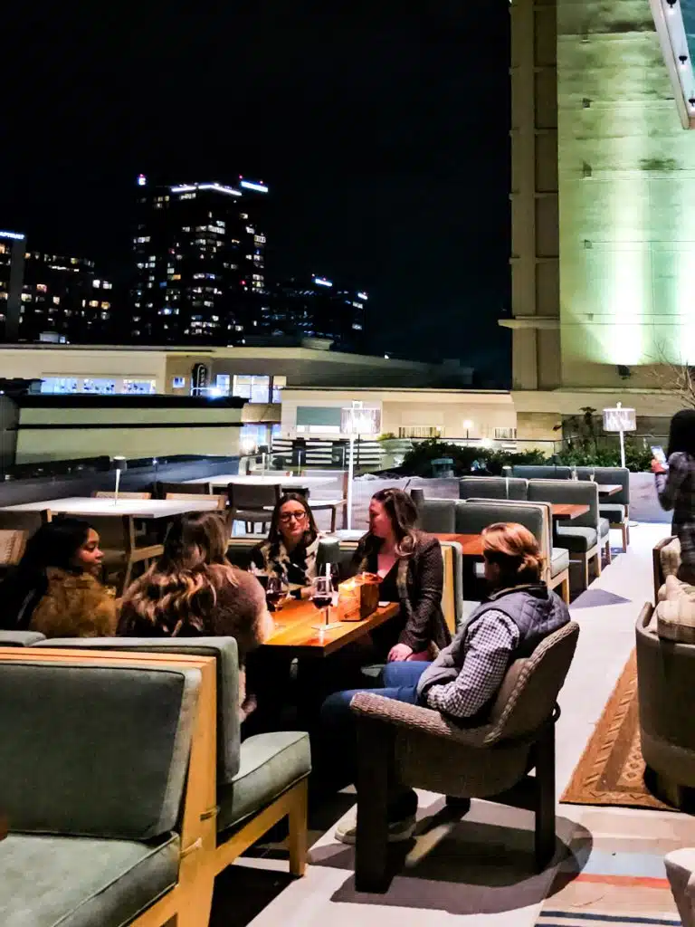 people sitting on rooftop of sixty vines north hills
