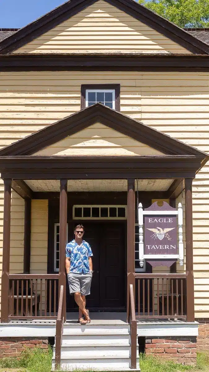 man outside the eagle tavern at halfiax historic park