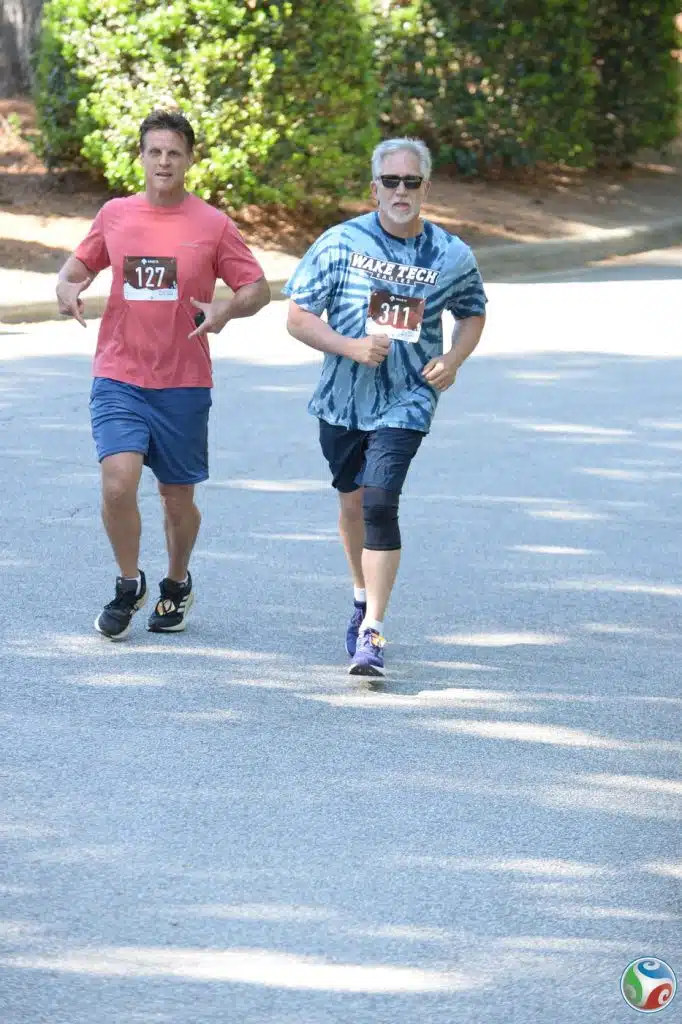 two men running wake tech reach rally run course