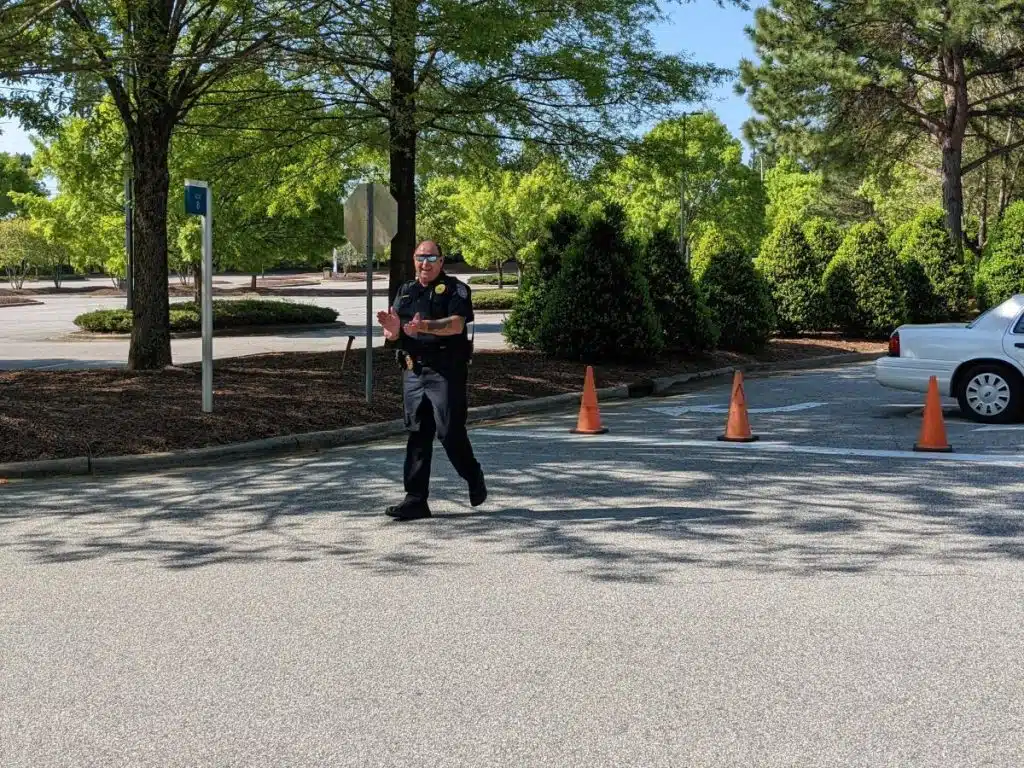 policeman on reach rally run course cheering on runners