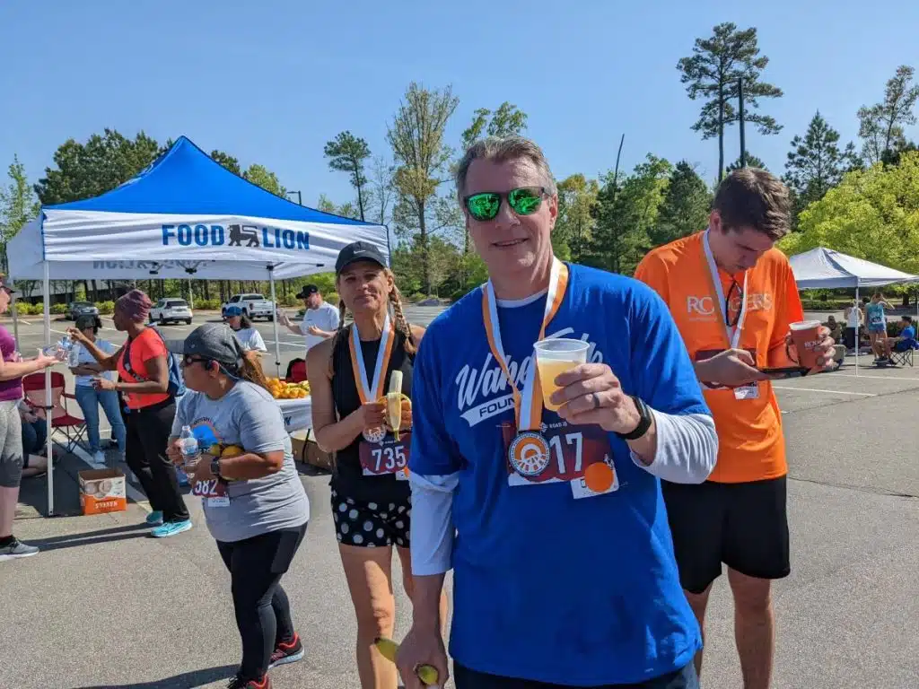 man holding beer in runner's village
