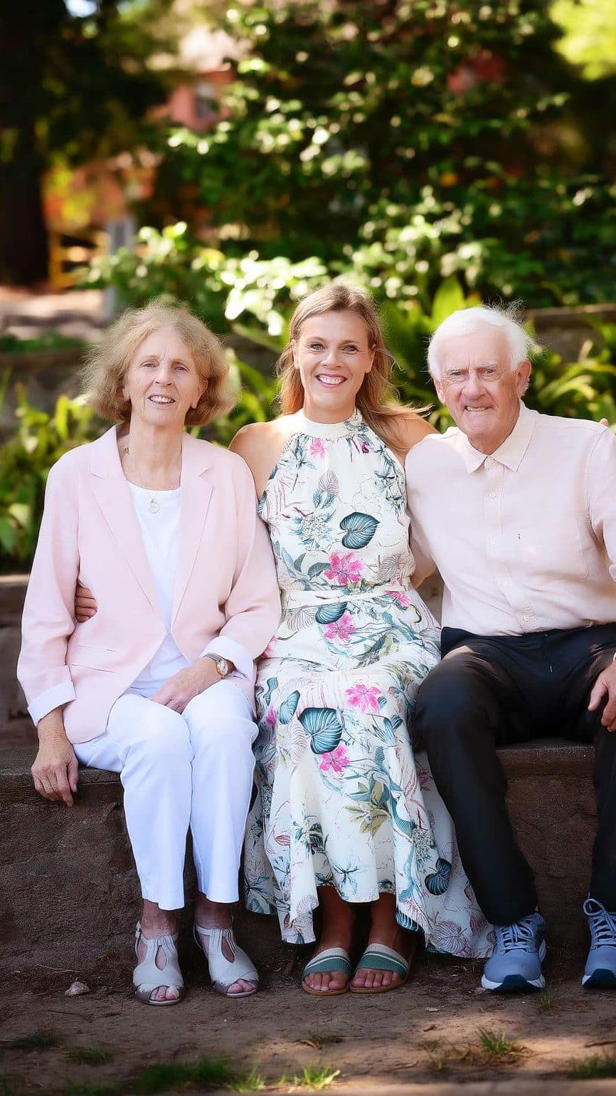 parents and daughter posing
