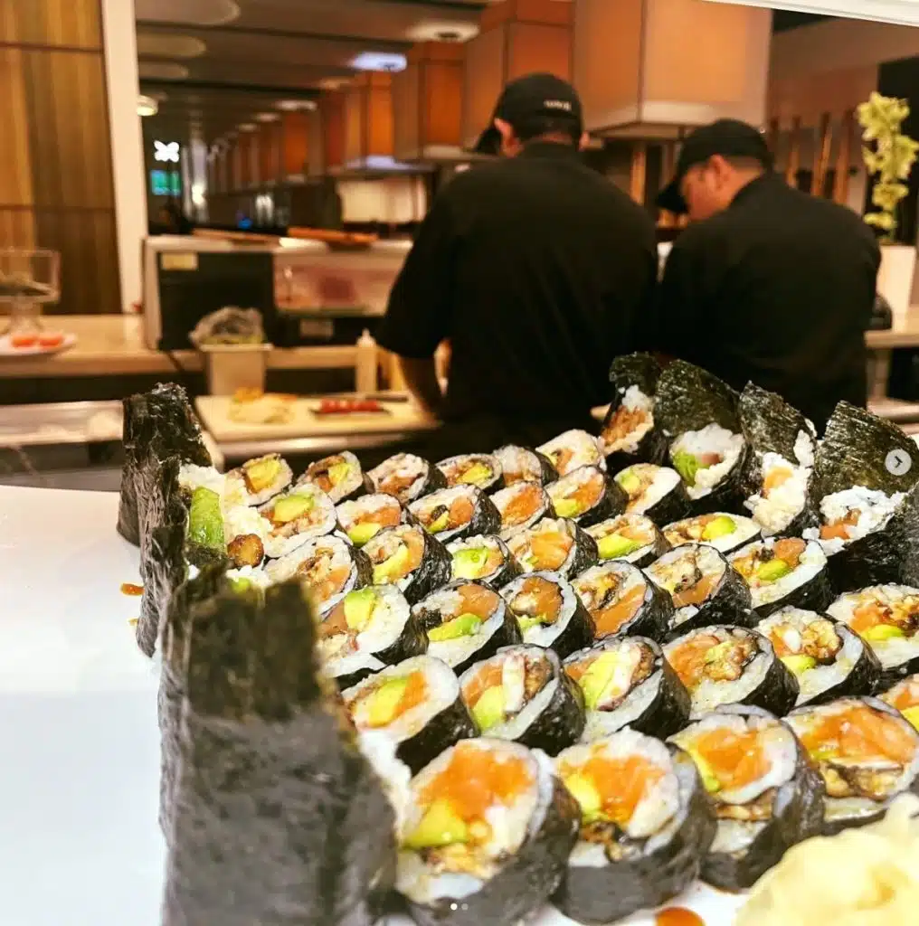 sushi on bar with two sushi chefs in background