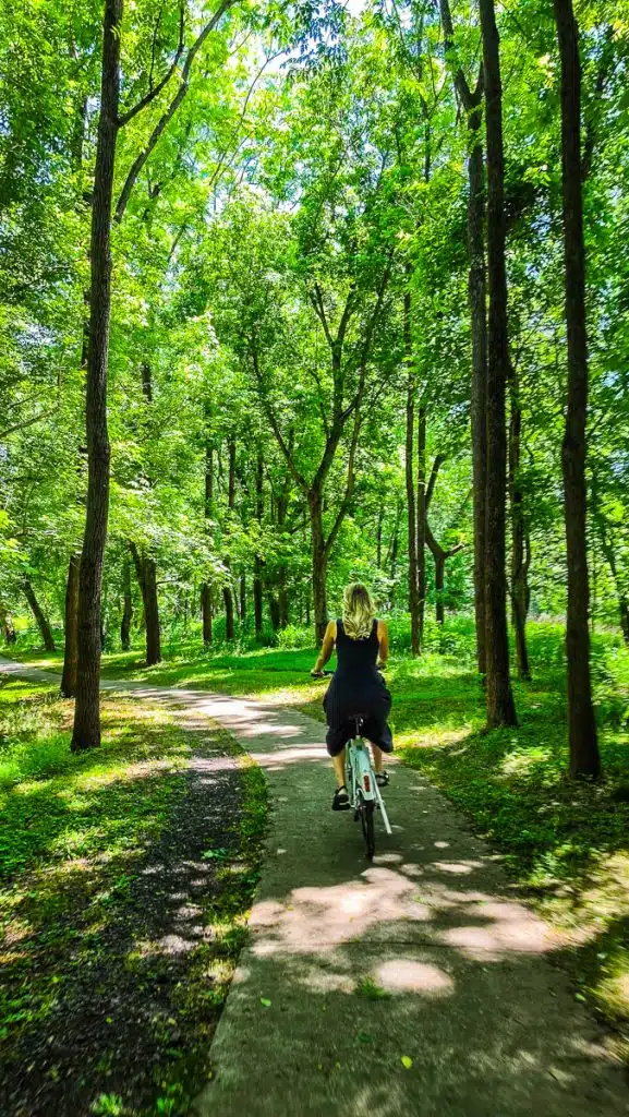 woman biking on river trail in danville