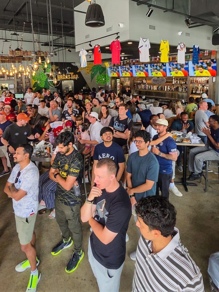 crowds watching soccer at brass tap