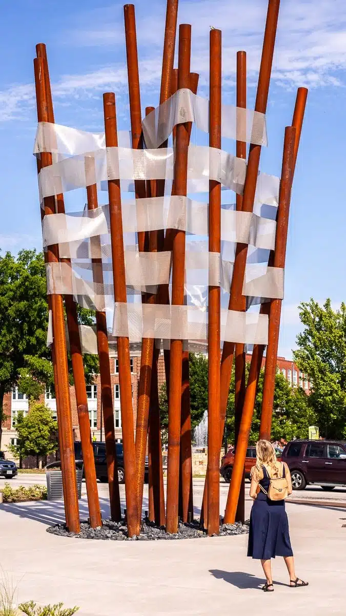 woman looking at art sculpture