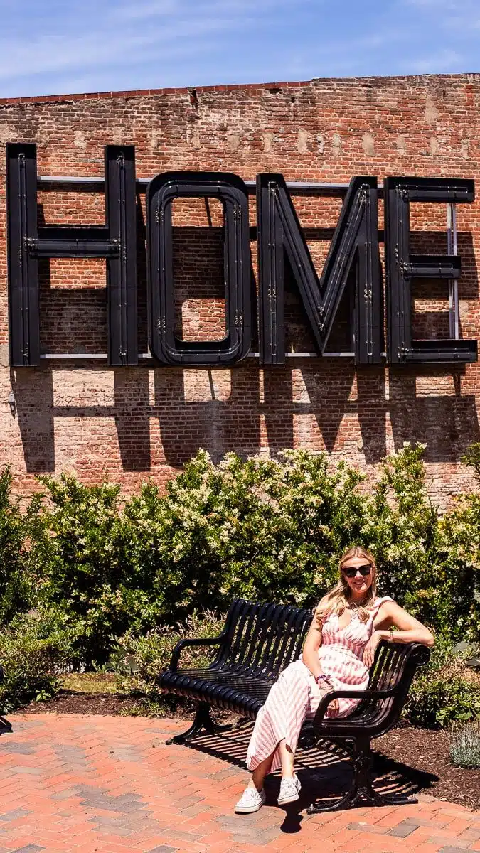woman sitting under home sign danville