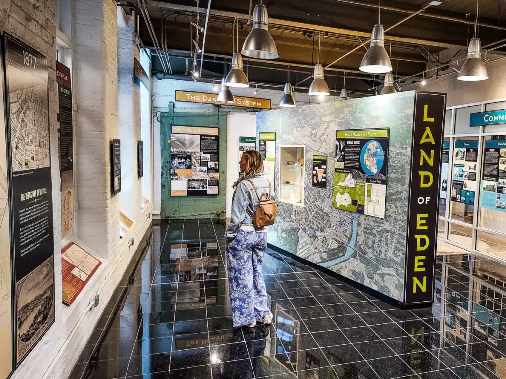 woman looing at exhibitions in the history hub danville