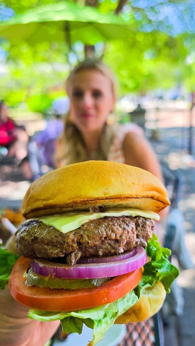 man holding burger at me's in danville
