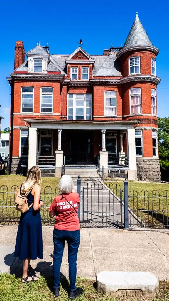 two women looking at historic home historic homes on millionaire row danville on walking tour