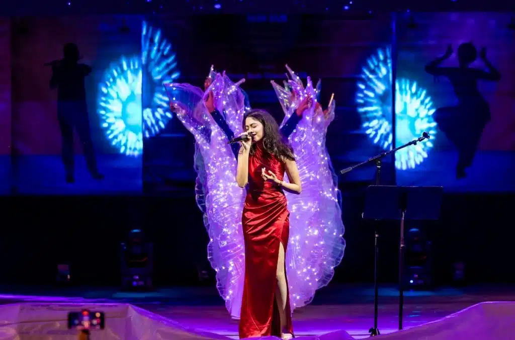 woman on stage singing at diwali cary
